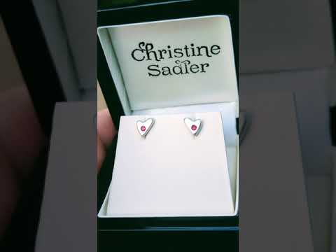 video of handmade silver heart earrings in a modern matt finish set with rubies