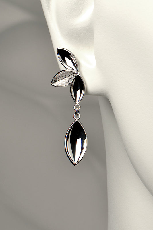 modern silver drop earrings with four concave silver shapes in highly polished and contrasting modern textured finish. Called The Promise, a tree is planted for each piece of this design sold by Christine Sadler