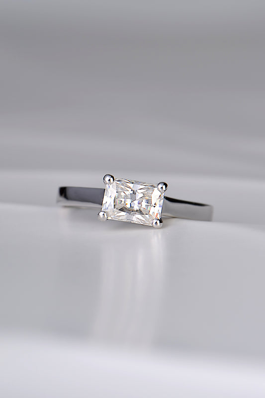 contemporary designer engagement ring handmade in the UK. Rectangular gemstone sitting across the ring in a white gold band.