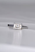 contemporary designer engagement ring handmade in the UK. Rectangular gemstone sitting across the ring in a white gold band.