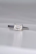 contemporary designer engagement ring handmade in the UK. Rectangular gemstone sitting across the ring in a white gold band.