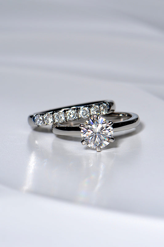 platinum diamond set wedding ring with 7 diamonds next to one carat diamond ring