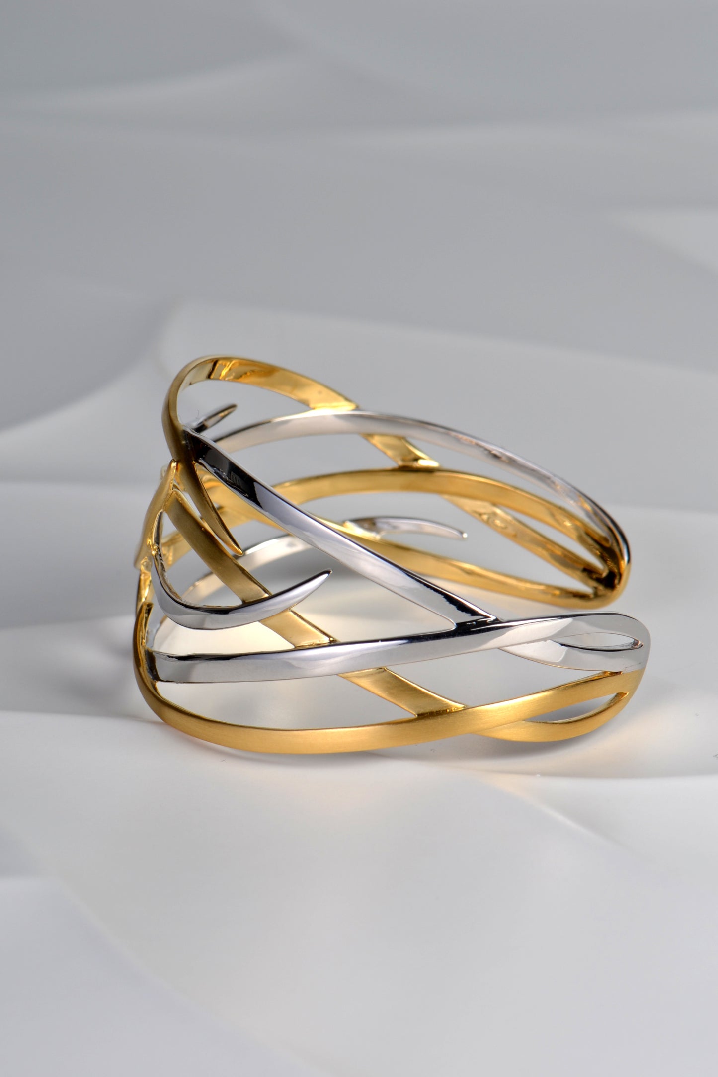 wide two tone statement cuff with overlapping silver and 18ct gold plate