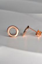 rose gold circle earrings shown side on so you can see that they are flat and sit close to the earlobe