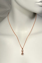 9ct rose gold elegant necklace in a double helix shape on a mannequin with a plain background from jewellery designer Christine Sadler