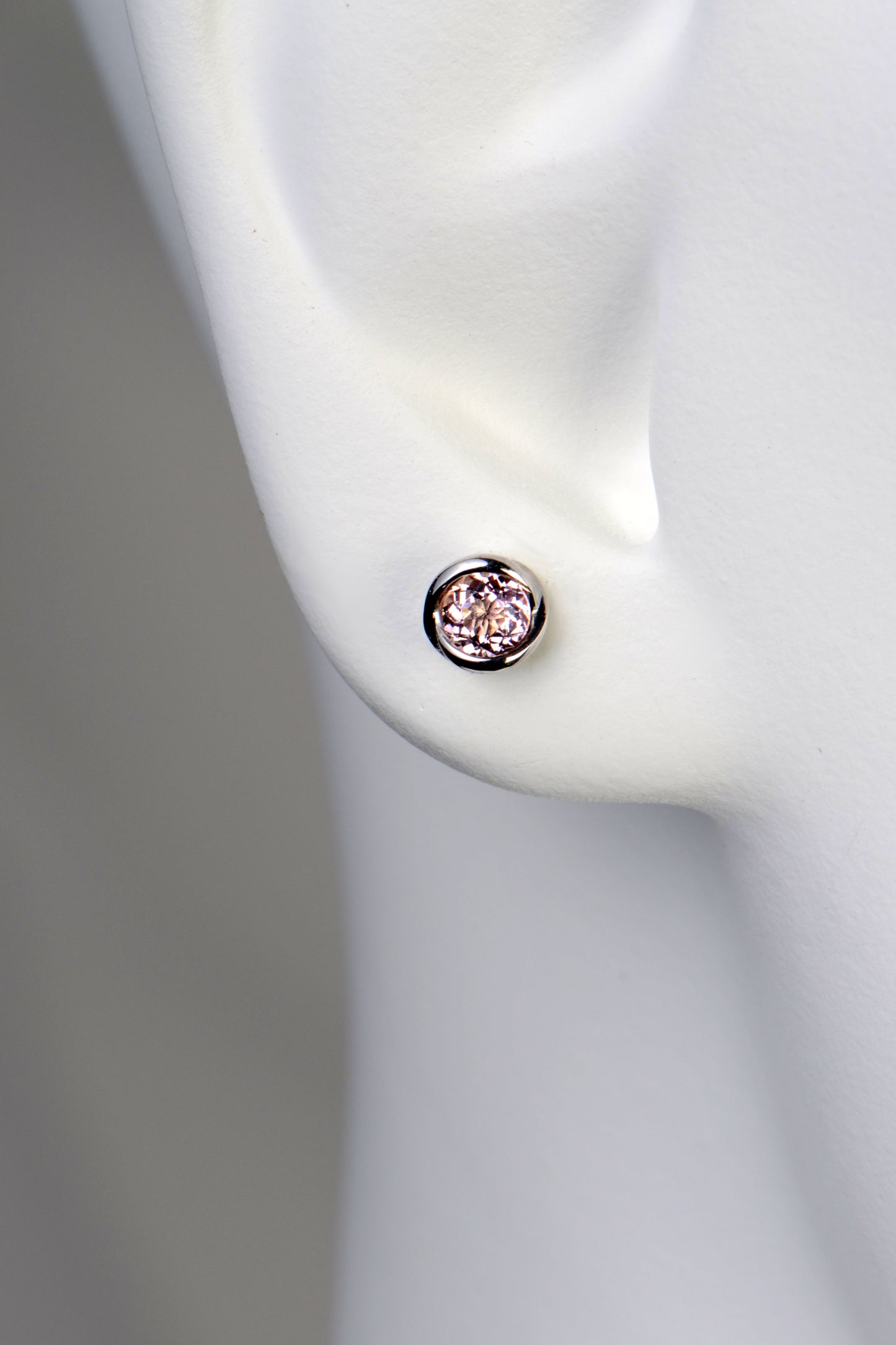 small round morganite earrings in a earlobe 