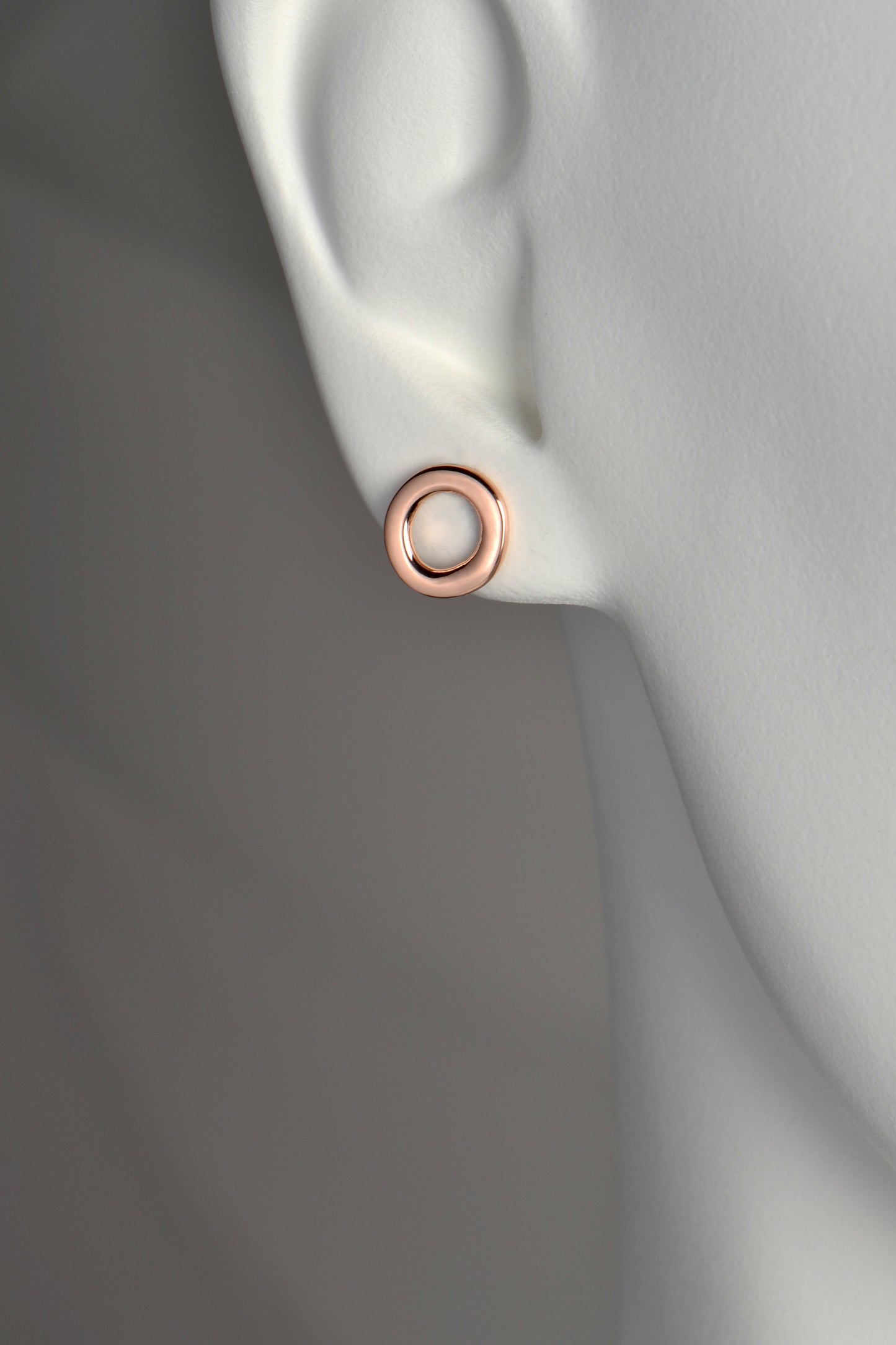 10mm round rose gold designer earrings that sit neatly on the earlobe