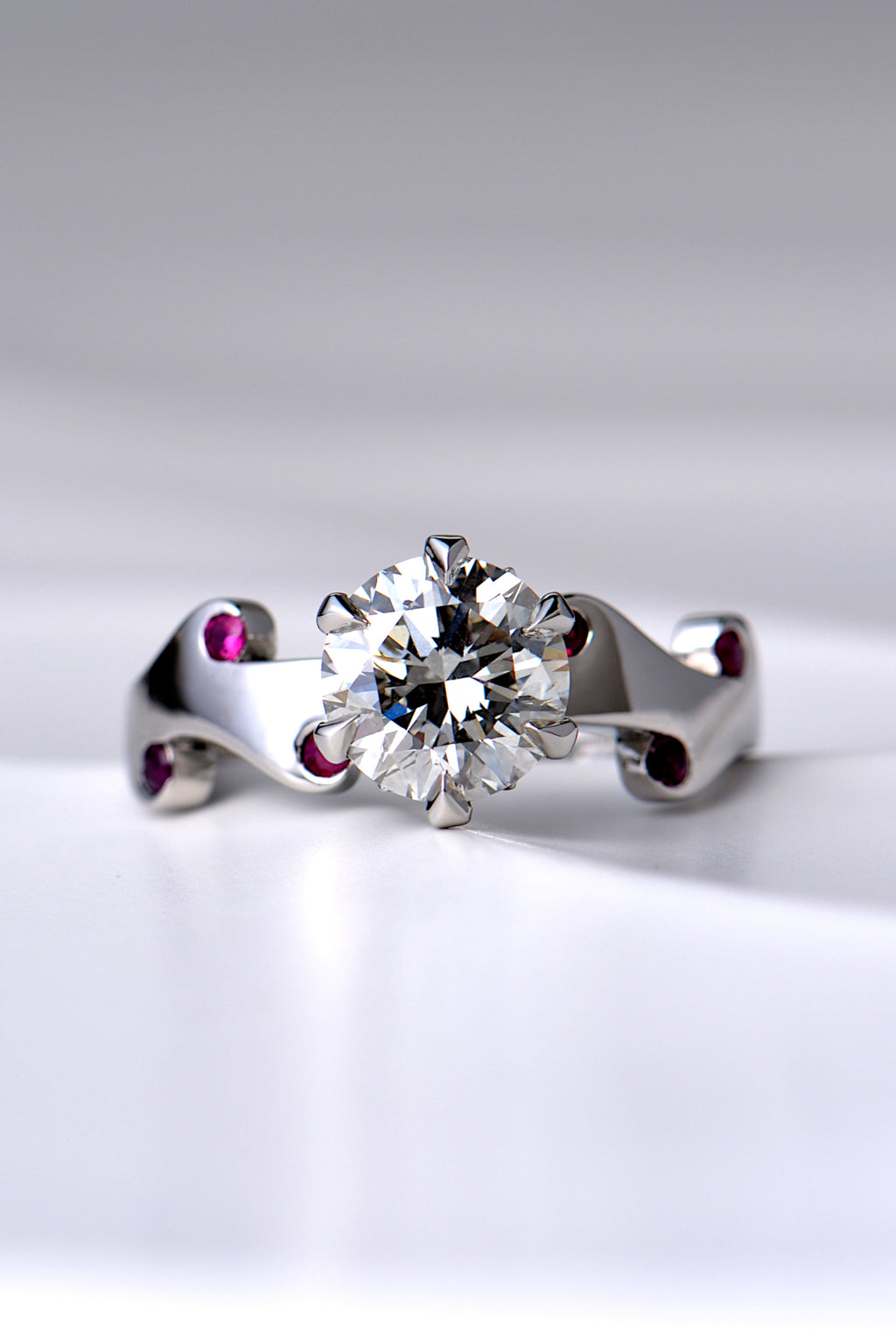 really special two carat diamond ring set with a large central diamond and six small rubies in a unique fire and flame design by scottish jewellery designer Christine Sadler