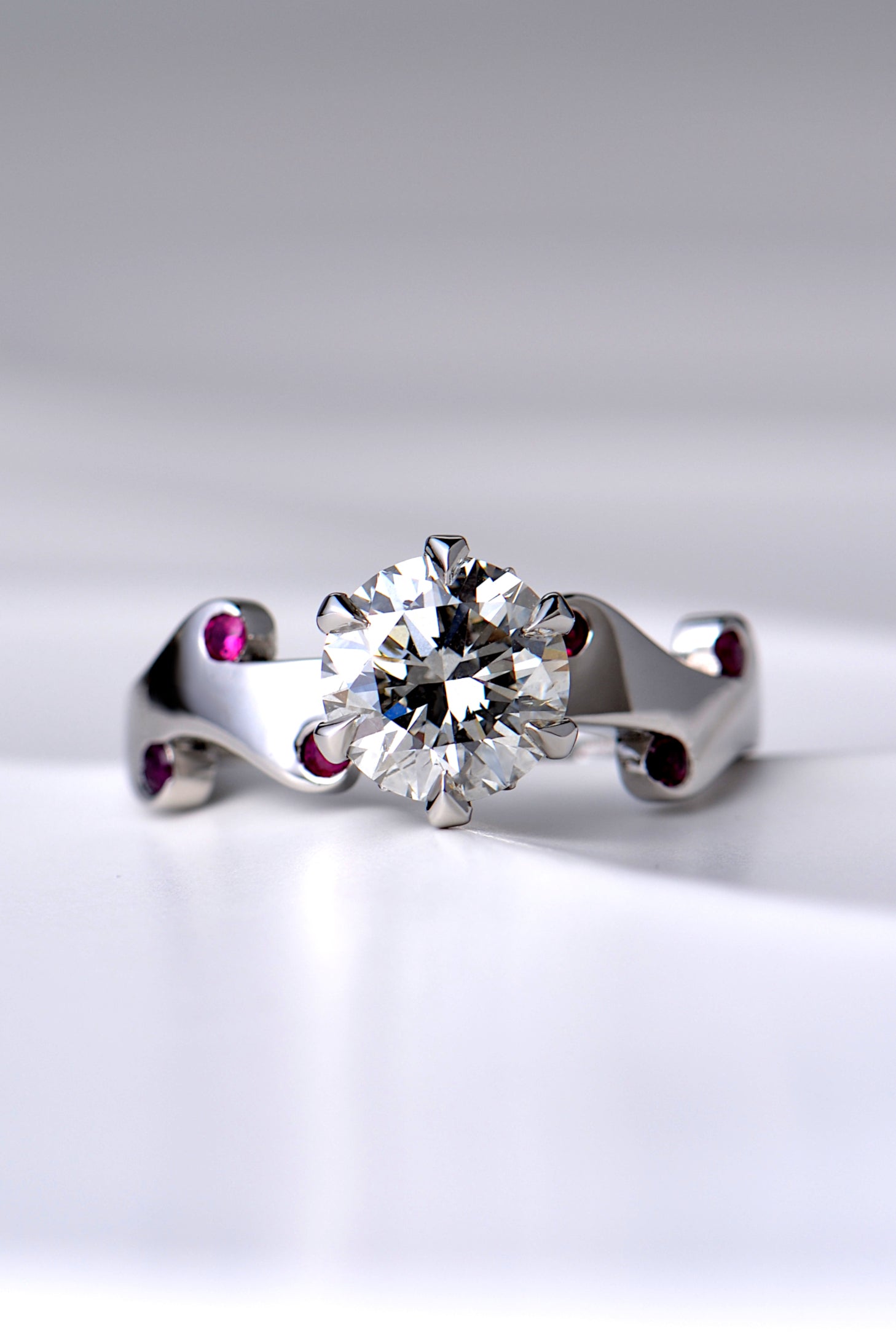 really special two carat diamond ring set with a large central diamond and six small rubies in a unique fire and flame design by scottish jewellery designer Christine Sadler