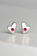 handmade designer silver heart earrings set with rubies by jewellery designer Christine Sadler