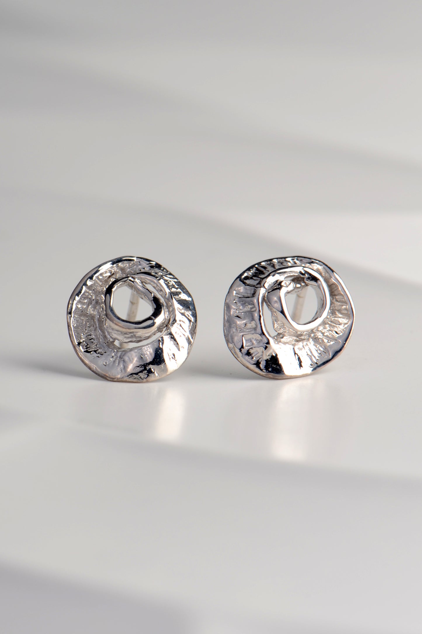 small silver earrings inspired by the texture of seaweed