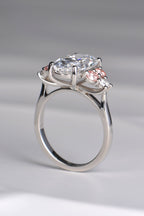 Rosé Spark platinum 950 ring viewed from below, showcasing the detailed setting and secure prong design beneath the central oval lab diamond and side stones
