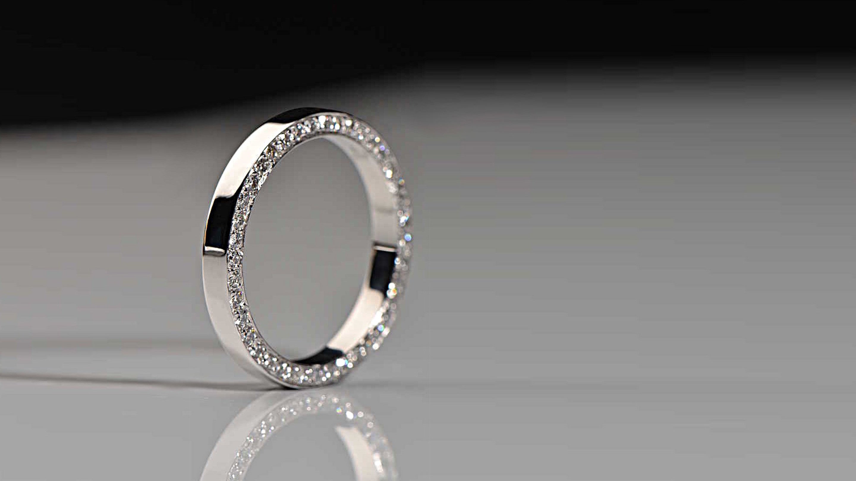 modern platinum wedding ring with diamonds on the side made in the UK from Christine Sadler