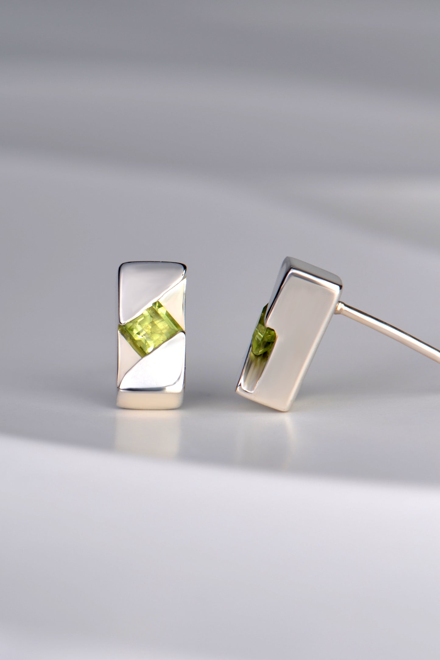 designer silver earrings set with a peridot