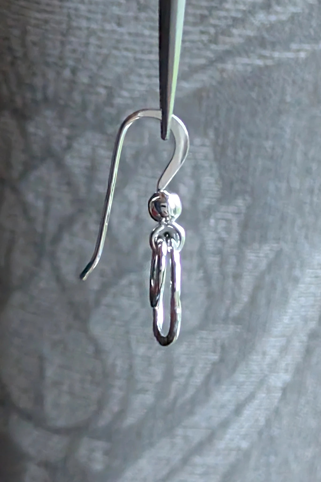 Side view of the double circle sterling silver drop earrings showing the elegant hook fitting.