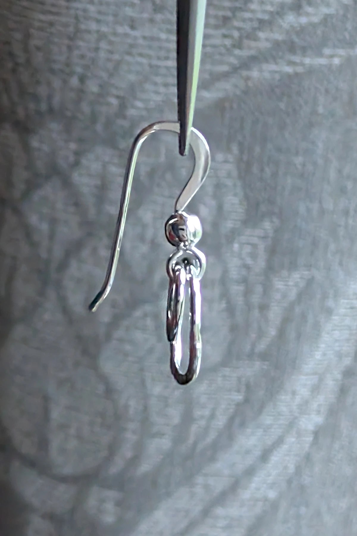 Side view of the double circle sterling silver drop earrings showing the elegant hook fitting.