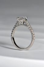 snuggle fit pear cut diamond engagement ring in platinum with diamonds in the shoulders