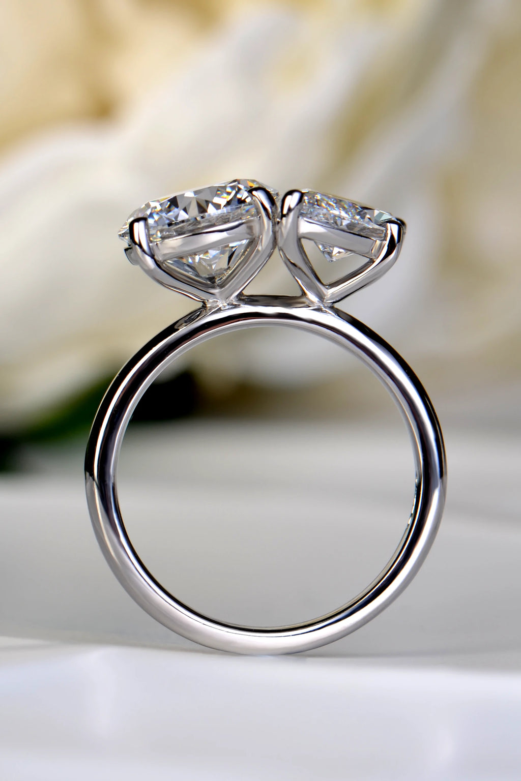 Open view through a platinum Toi et Moi ring band demonstrating the elevated, sculptural settings that allow a straight wedding band to sit flush by Christine Sadler