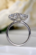 Open view through a platinum Toi et Moi ring band demonstrating the elevated, sculptural settings that allow a straight wedding band to sit flush by Christine Sadler