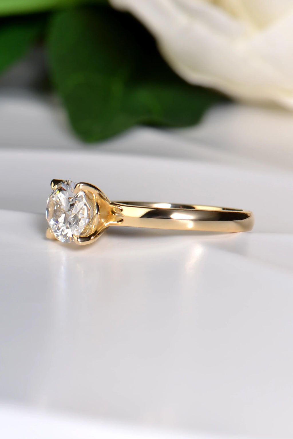 Side view showing the high quality 2.3mm wide band on the 18ct yellow gold 2ct oval lab diamond ring.
