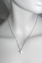 Sterling silver double heart necklace set with aquamarine displayed on white mannequin to show size and scale. 