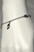 modern silver charm bracelet with concave seed shapes. For each bracelet sold, a tree is planted - Christine Sadler