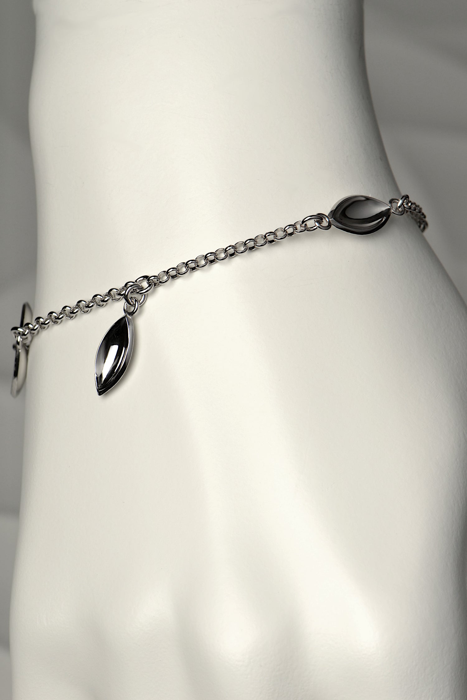 modern silver charm bracelet with concave seed shapes. For each bracelet sold, a tree is planted - Christine Sadler