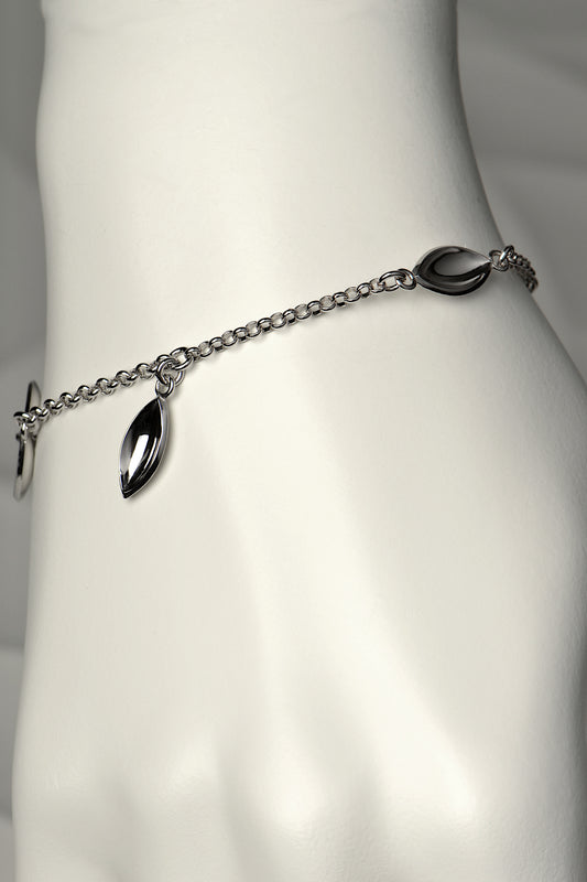 modern silver charm bracelet with concave seed shapes. For each bracelet sold, a tree is planted - Christine Sadler
