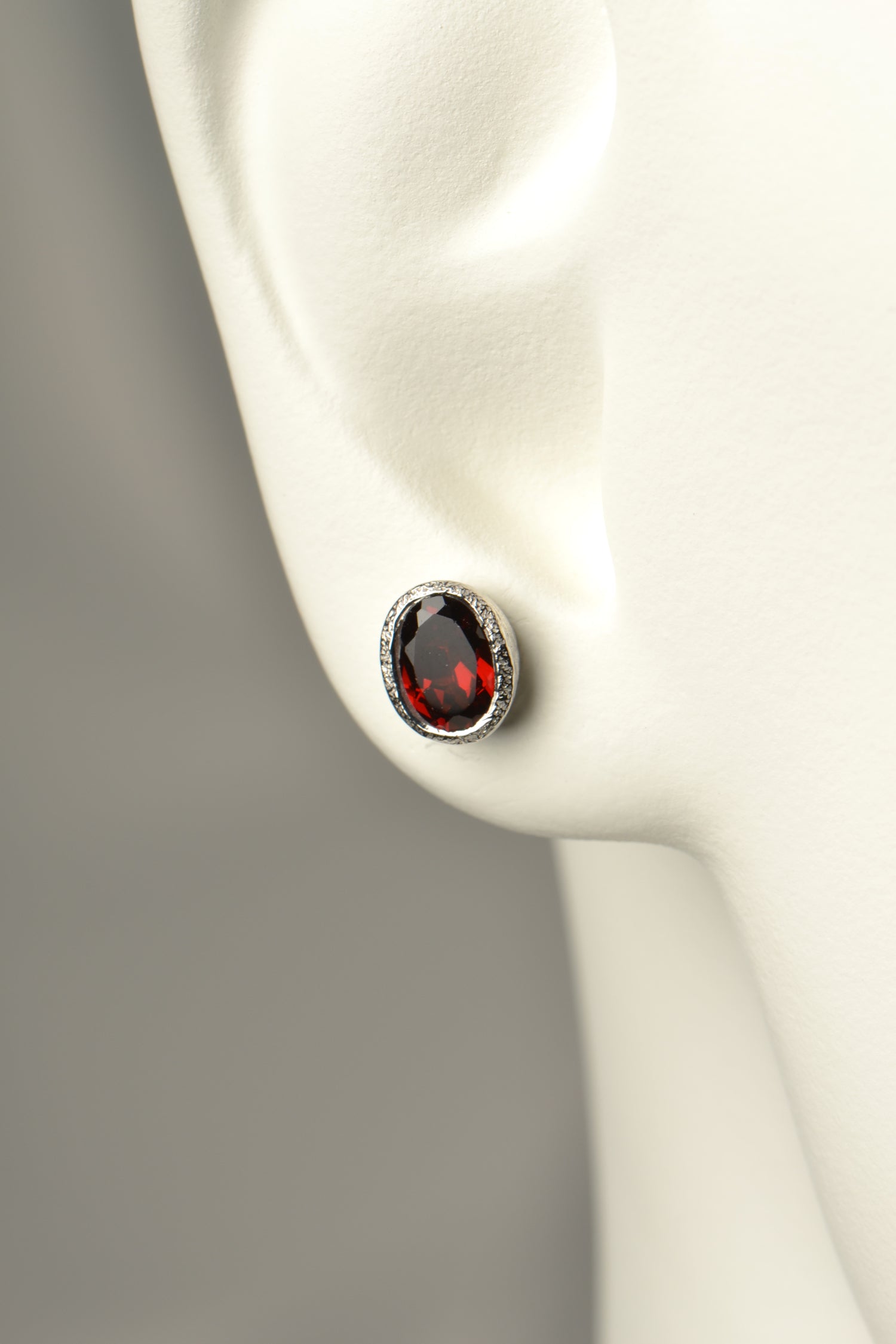 oval garnet earrings in a handmade silver stud design