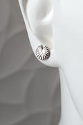 Sterling silver Break the Wheel talisman round stud earring shown on a mannequin ear to show size and scale