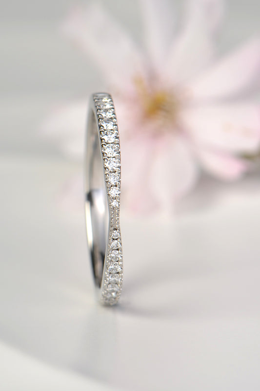 gorgeous platinum skinny diamond wedding ring that is pinched in the middle