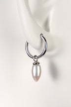 small silver hoop earrings with white pearls designer Jorge Revilla