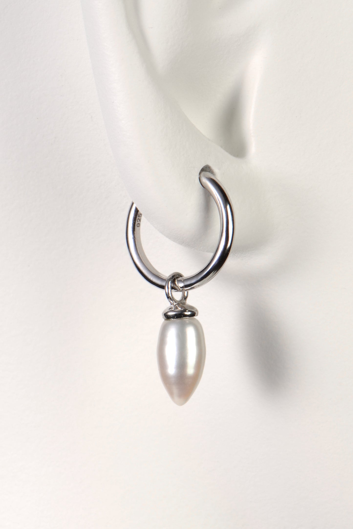 small silver hoop earrings with white pearls designer Jorge Revilla