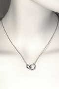 interlocking silver circle necklace with two oval egg shaped links at the front, one larger and one smaller, on a fine silver chain. Part of Christine Sadler's Soulmates collection