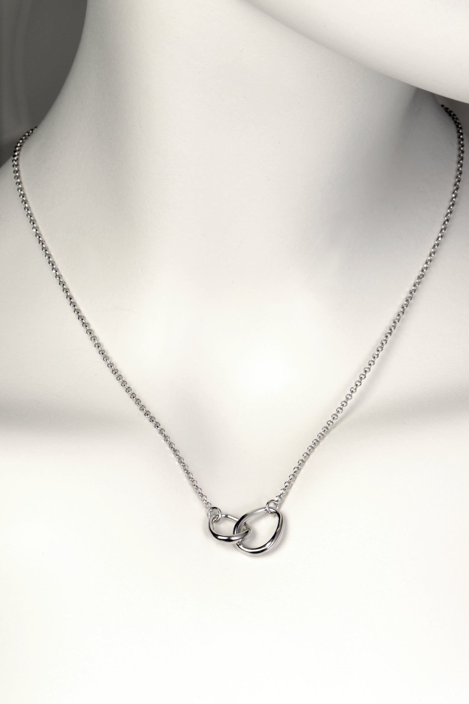 interlocking silver circle necklace with two oval egg shaped links at the front, one larger and one smaller, on a fine silver chain. Part of Christine Sadler's Soulmates collection