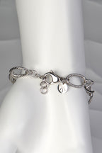 Silver Designer Genes bracelet displayed on a white mannequin hand, showing elegant scale and fit with adjustable clasp
