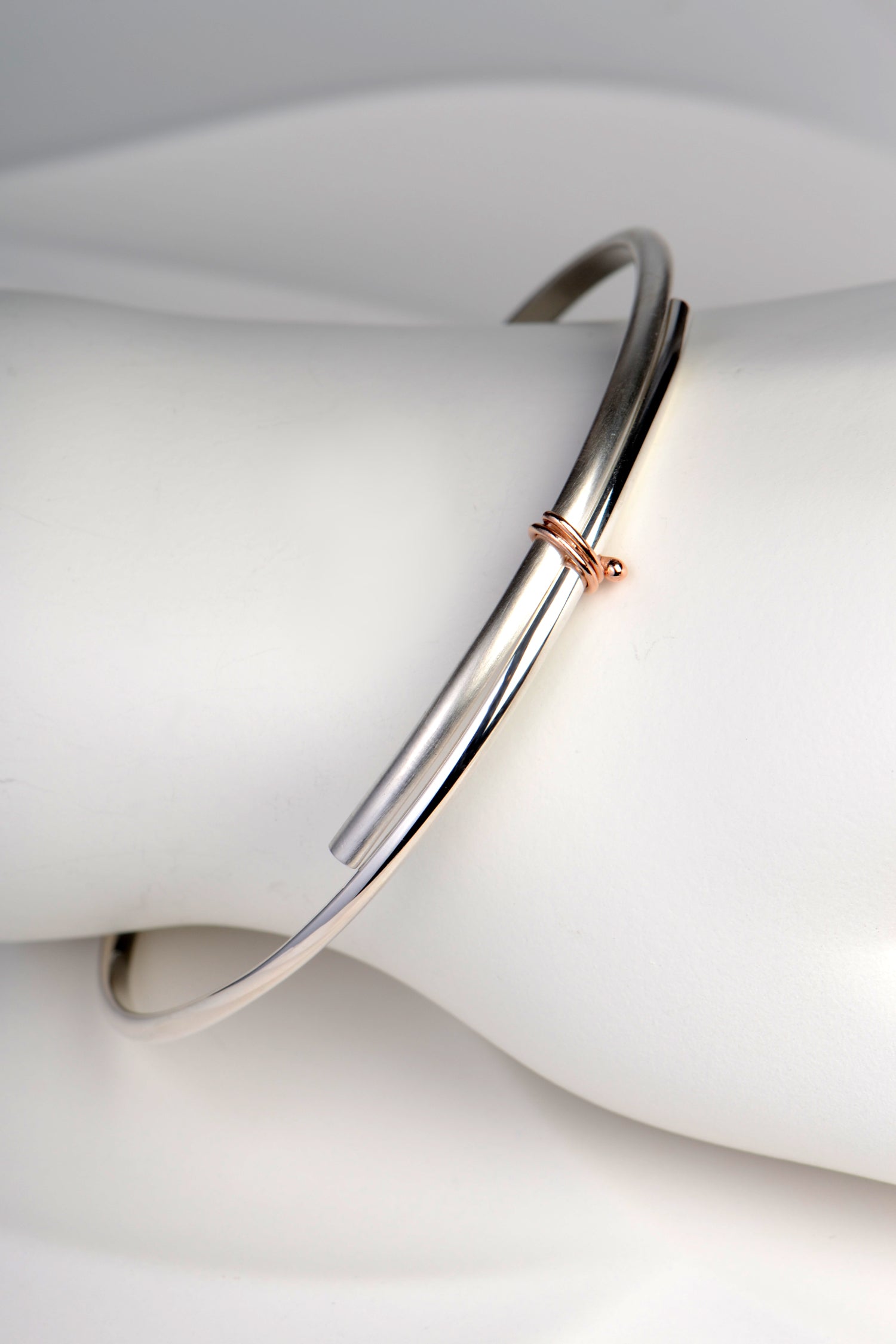 handmade slim silver and rose gold designer bangle exclusively available from UK jewellery designer Christine Sadler