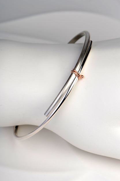 handmade slim silver and rose gold designer bangle exclusively available from UK jewellery designer Christine Sadler
