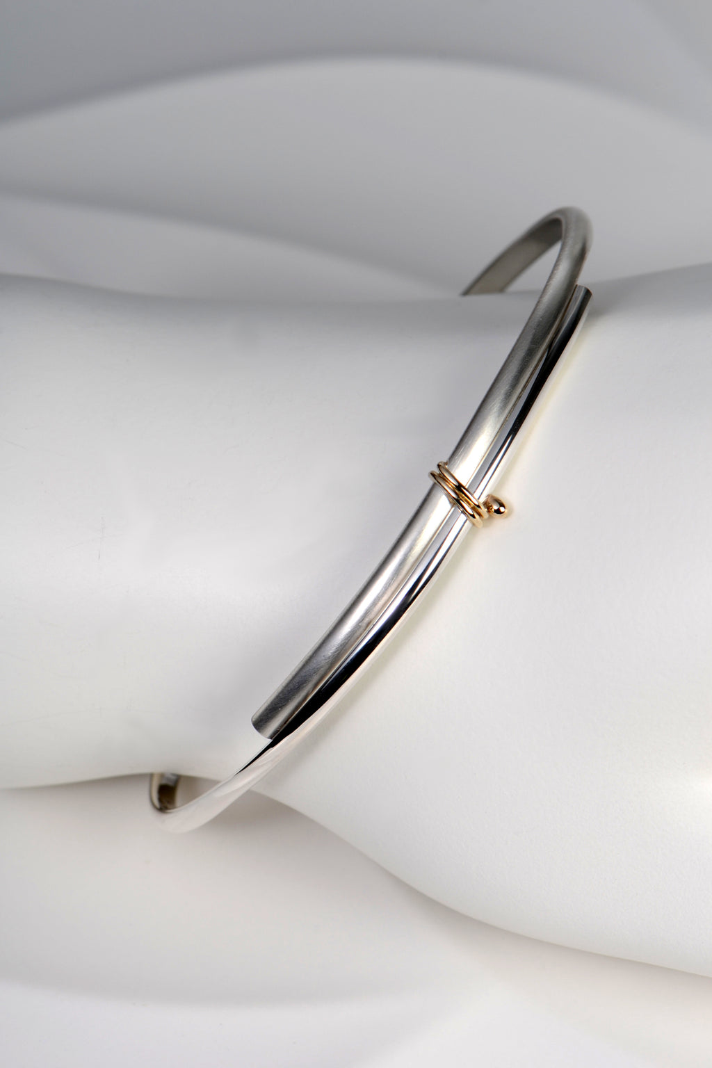modern silver and gold handmade designer bangle exclusively available from jewellery designer Christine Sadler