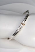 modern silver and gold handmade designer bangle exclusively available from jewellery designer Christine Sadler