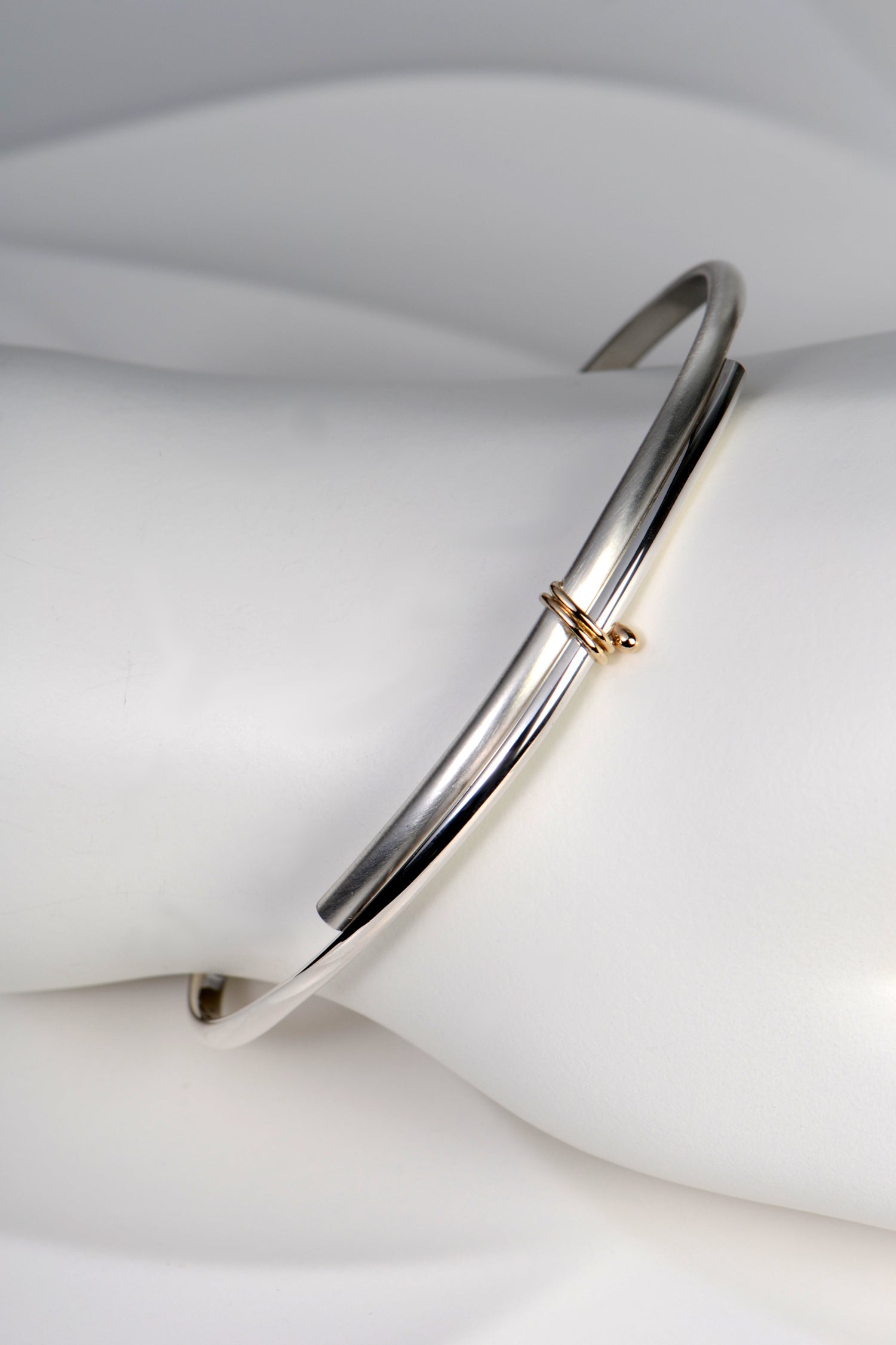 modern silver and gold handmade designer bangle exclusively available from jewellery designer Christine Sadler