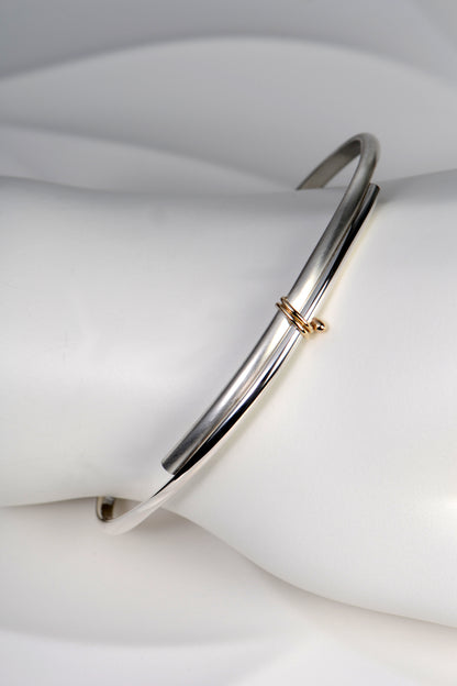 modern silver and gold handmade designer bangle exclusively available from jewellery designer Christine Sadler