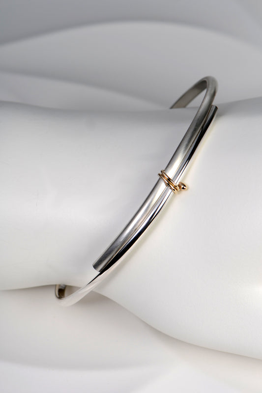 modern silver and gold handmade designer bangle exclusively available from jewellery designer Christine Sadler
