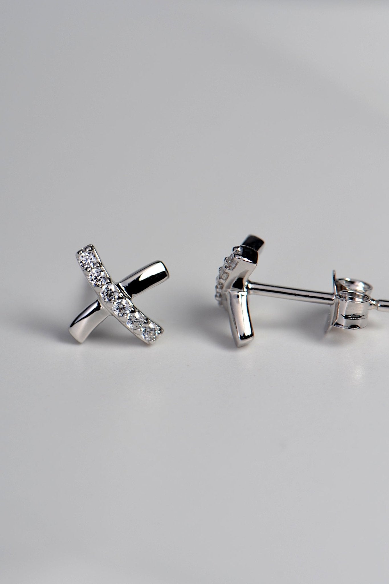 sterling silver stud earrings in a cross shape like a kiss with sparkling cubic zirconias