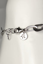 adjustable silver bracelet that an be made larger or smaller with Christine Sadler's benchmark branded logo tag at the clasp