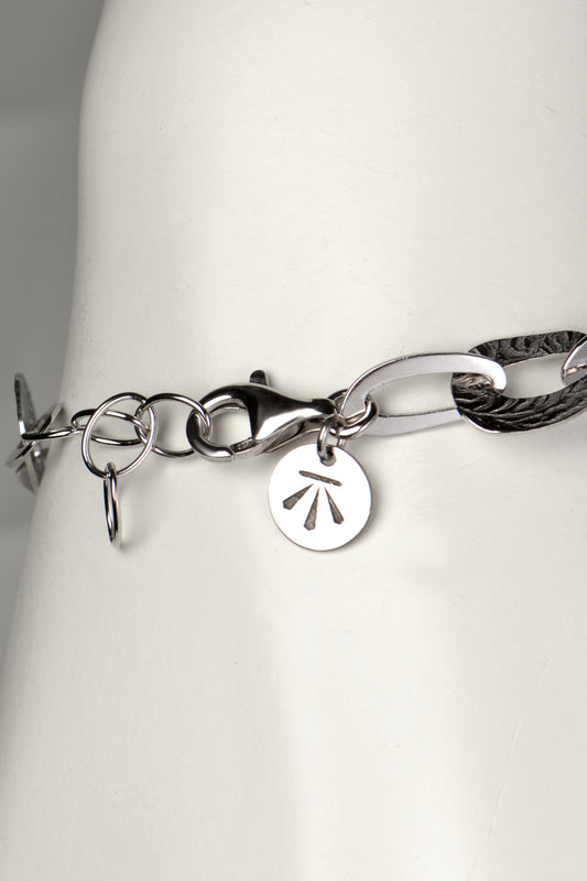 adjustable silver bracelet that an be made larger or smaller with Christine Sadler's benchmark branded logo tag at the clasp