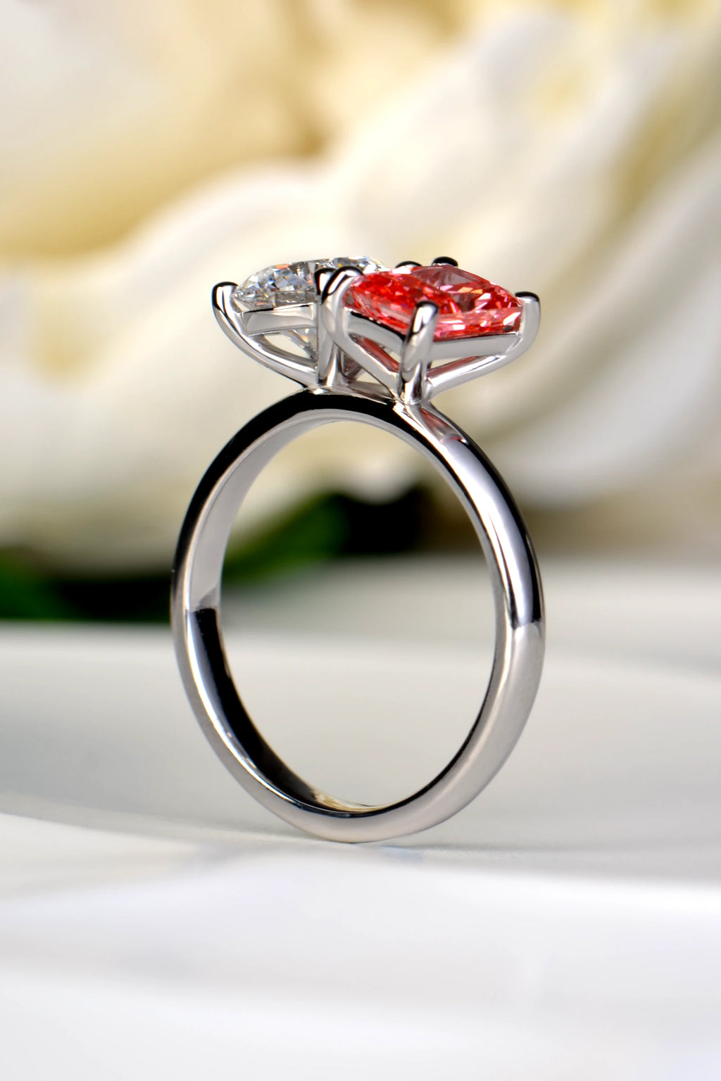 Three-quarter angle of a platinum Moi et Toi diamond ring displaying elevated gemstone settings sitting above the band for a seamless snuggle fit, by Christine Sadler