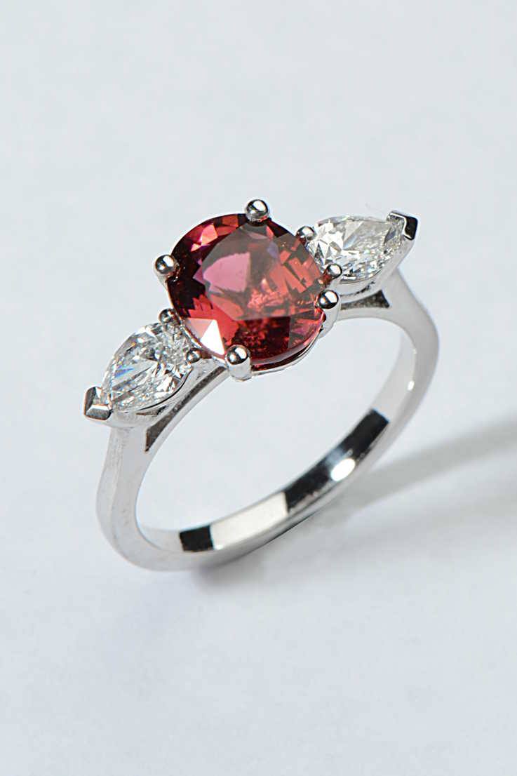 one-of-a-kind three stone platinum engagement ring with an oval red tourmaline in the middle and a pear cut diamond on either side - Christine Sadler