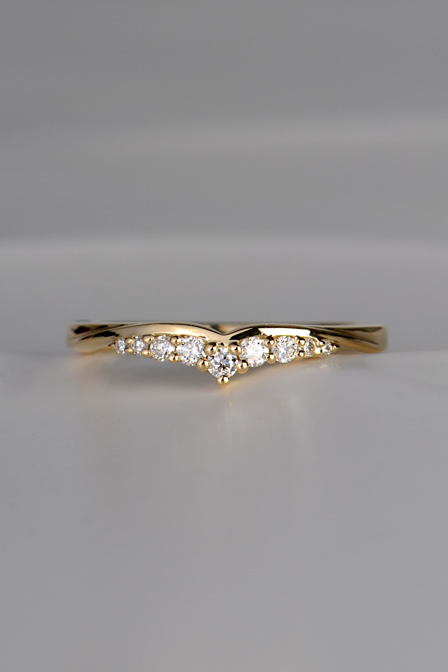 shaped wedding ring for a woman in 18ct gold with 9 diamonds that create the look of a tiara.