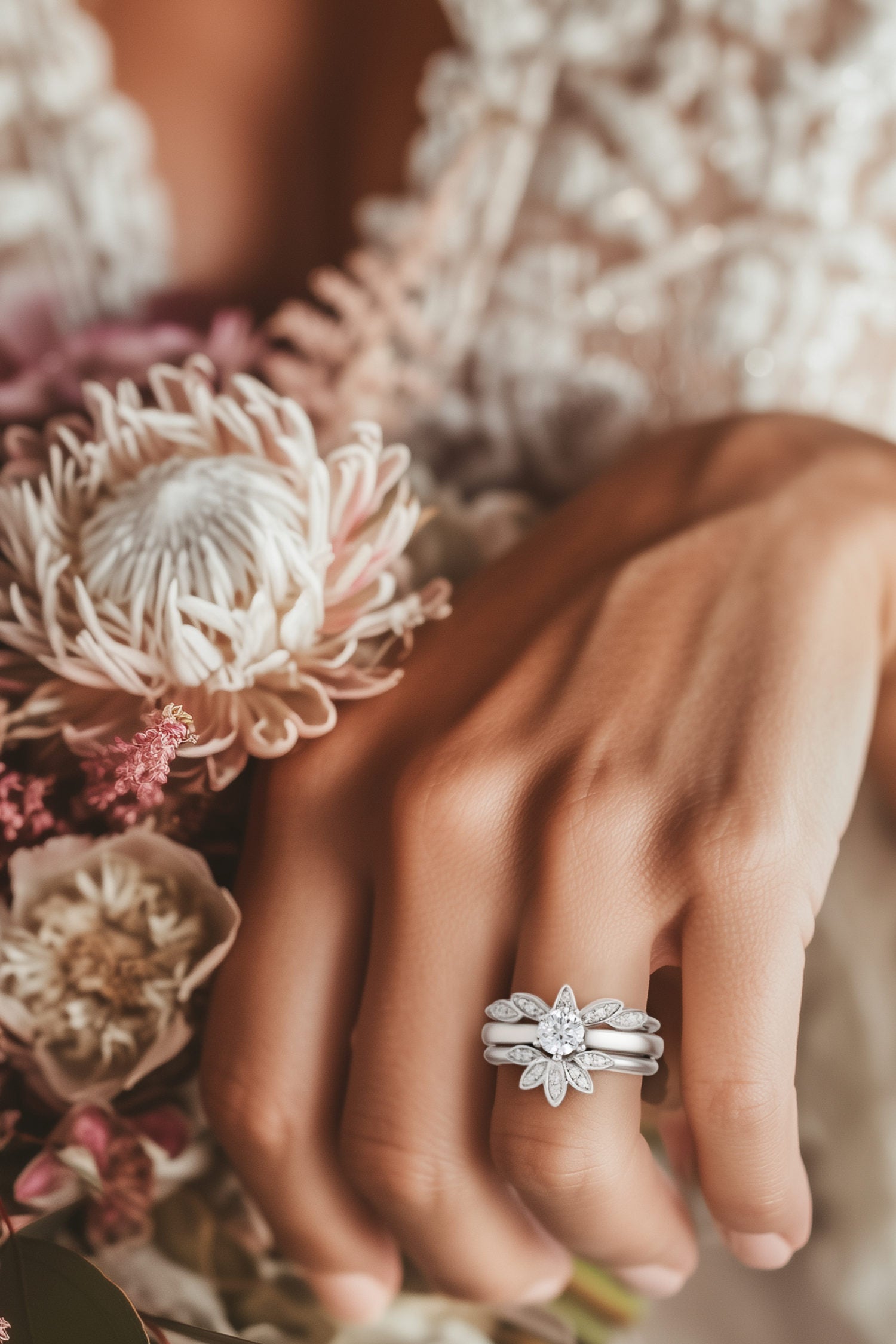 Bride showing off her engagement ring with a five petal platinum wedding guard ring on either side - Christine Sadler